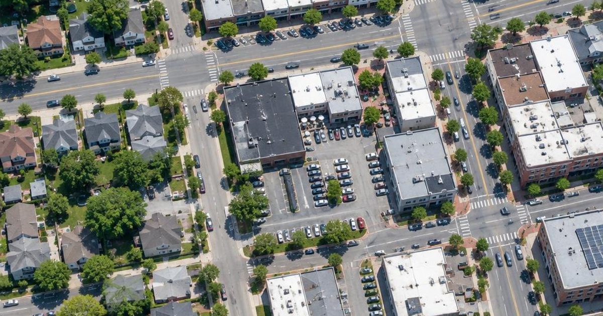 GMBRank.ai illustrates a local business service area with aerial neighborhood streets.
